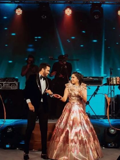 The couple taking center stage during their grand entry, complete with backup dancers using ribbon props.