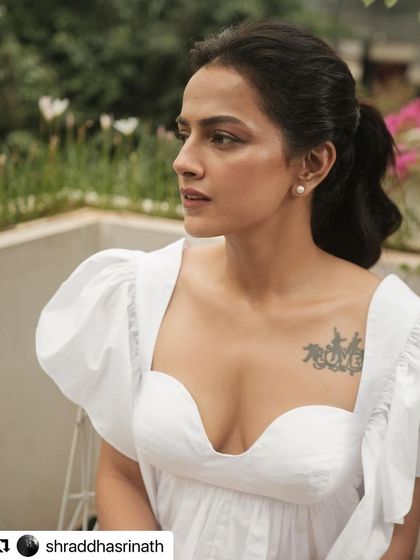 A close-up portrait from the shoot, focusing on the delicate pearl earrings and soft, natural makeup that complemented the romantic feel of the outfit.