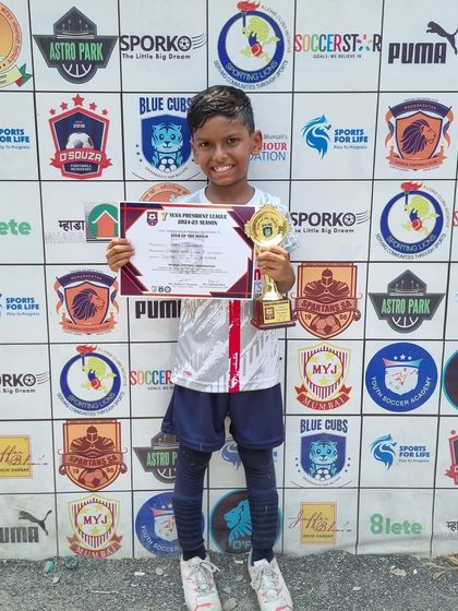 Jaden proudly holding his 'Player of the Match' award after a fantastic performance in the U7 league.