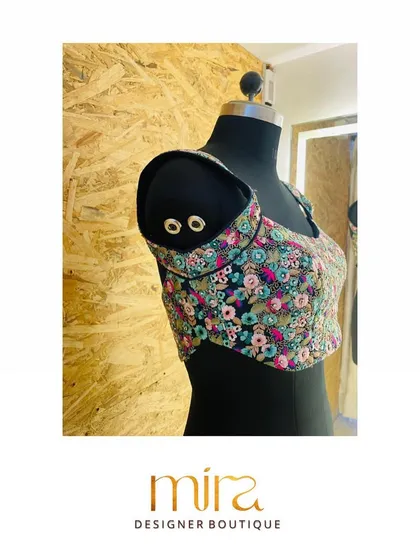 A side profile of the floral sequin blouse, showing the unique shoulder detail and precise cut. I focus on creating patterns that are not only beautiful but also provide a flattering and comfortable fit.