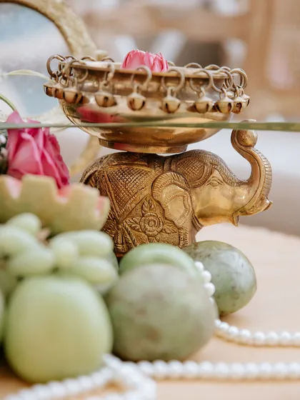 A close-up of the ornate brass elephant holding a bowl with a floating lotus, a nod to traditional Indian artistry.