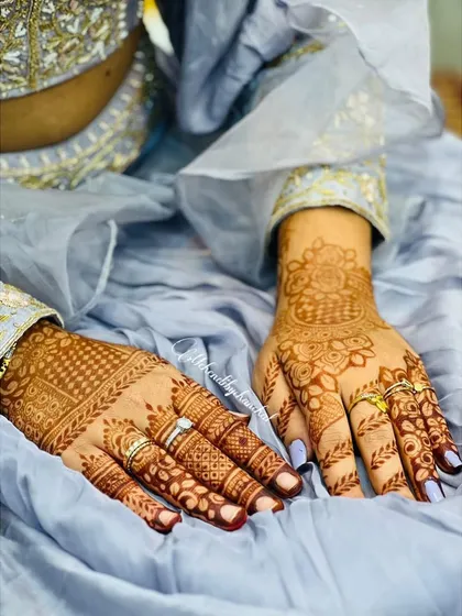 A close-up of the stained Diwali mehendi, showing the beautiful rings and festive attire.
