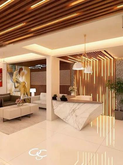 A render of a sophisticated commercial lobby and reception area we designed. The space features a marble reception desk, elegant wood slat ceilings with integrated lighting, and a vertical garden wall, creating a welcoming and luxurious atmosphere.