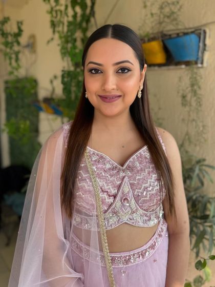 Another angle of the bride in her lilac lehenga, showcasing the versatility of the soft glam look in different lighting.