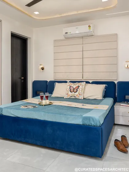 I love how this fresh and elegant royal blue bedroom turned out. The plush, upholstered bed frame adds a touch of luxury, while the neutral walls and flooring keep the space feeling bright and airy.