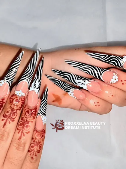 This angle showcases the dramatic length and sharp point of the zebra print stiletto nails, a truly head-turning set.