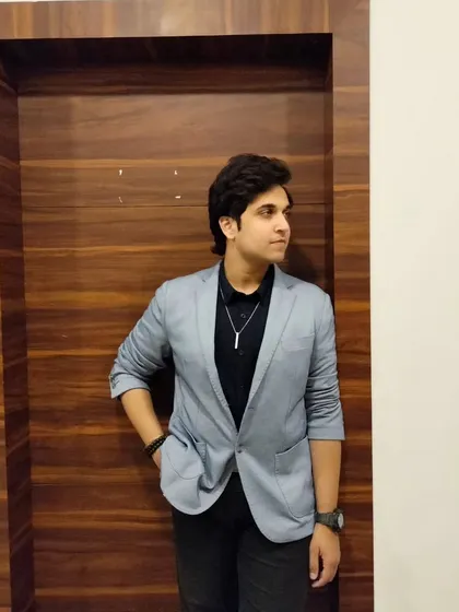A smart-casual look with a grey blazer over a black shirt. This versatile style is great for corporate, lifestyle, or semi-formal product shoots.