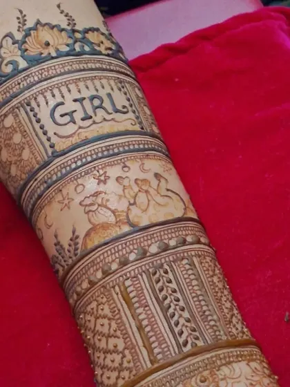 This shot shows the full arm design for the baby shower mehendi. The combination of text, illustrations, and traditional patterns makes it a truly special piece.