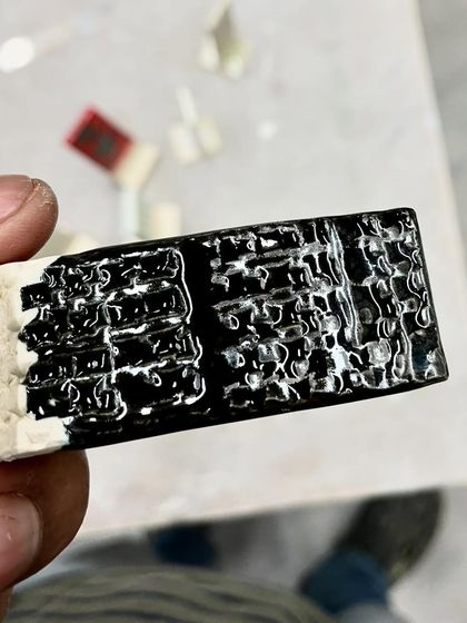 Another glaze test, this time with a thick, glossy black glaze that crawls and pulls apart to create a reptilian skin-like texture.