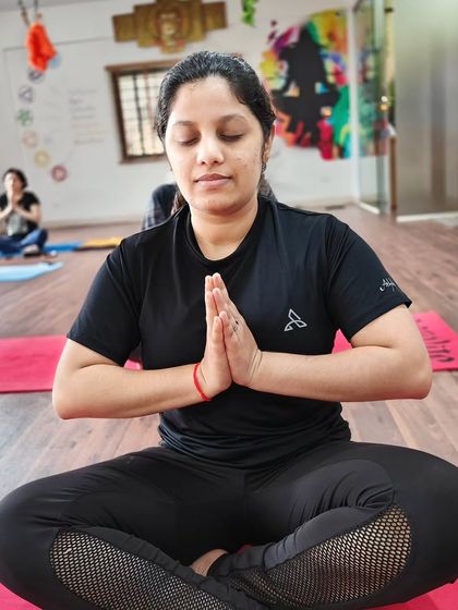 Another student deep in meditation, demonstrating the calm and focus we cultivate in our classes.