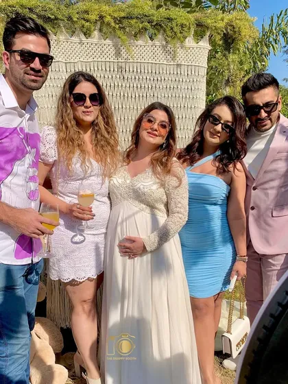 Friends and family celebrating the mom-to-be at her beautiful outdoor baby shower. Our booth captures these precious moments of support and love.