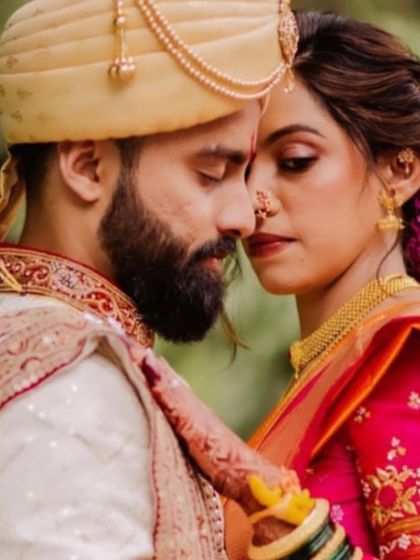 An intimate moment captured, with the bride's beautiful floral bun adding to the romance of the scene.