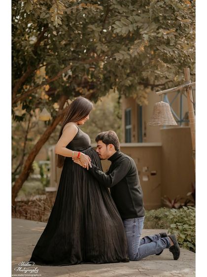 A classic and heartfelt pose where the dad-to-be connects with the baby bump. These are the moments filled with love and anticipation that you'll cherish forever.