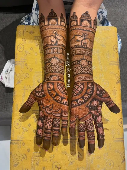 A beautiful bridal mehendi with a focus on elephant motifs. The design includes the groom's name, "Shubham," for a personal touch.