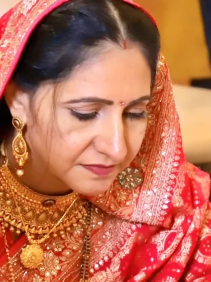 A close-up of a beautiful mother, her makeup soft and understated to complement her heavy traditional jewelry.