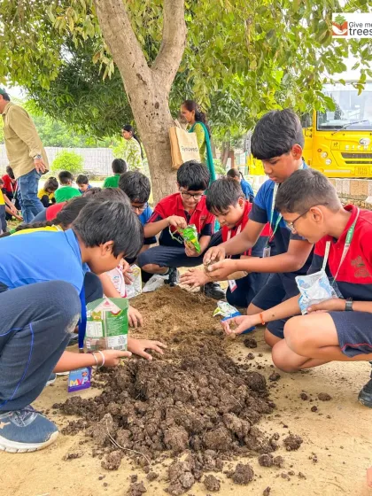 Students at DLF World School get their hands in the soil to make seed balls. This activity is a simple, effective, and fun way to teach them about reforestation.