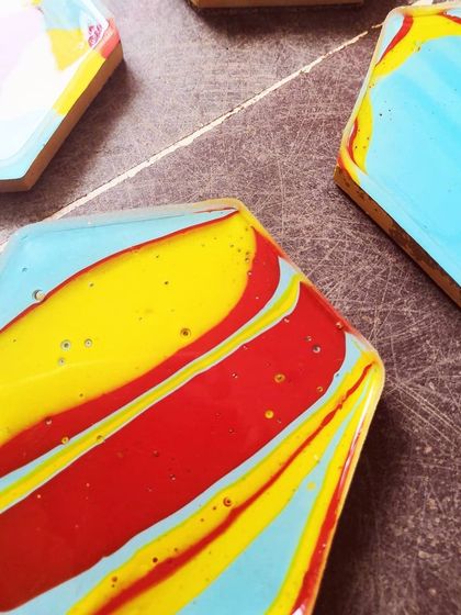 Another angle on the coasters, showing the glossy resin top coat. They are made from concrete, giving them a nice weight and feel.