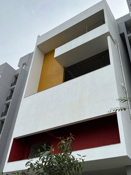 The use of primary colors on the facade of "The Treehouse" creates a playful and modern aesthetic, distinguishing it from typical apartment buildings.