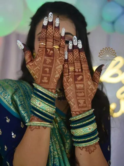 A beautiful shot of a client enjoying her baby shower. Her hands showcase the intricate back hand design filled with baby themed motifs.