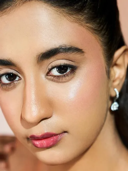 Skin should always be the hero. This close-up shows a flawless, luminous complexion that looks both natural and perfected.