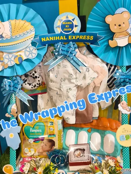 A full view of the 'Nanihal Express' hamper, decorated with blue paper fans and teddy bear cutouts.