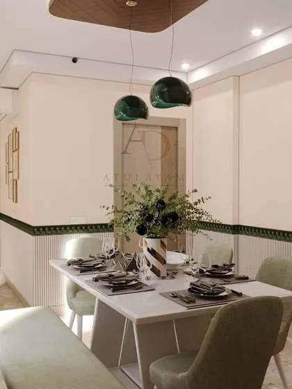 This dining area features elegant pendant lights and fluted wall paneling, creating a sophisticated space for meals.