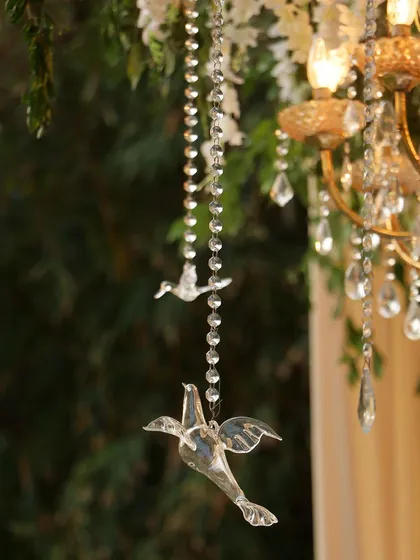 It's all in the details. These delicate crystal birds hanging from beaded strings were part of a larger floral installation, adding a touch of whimsy and sparkle that catches the light and the eye.