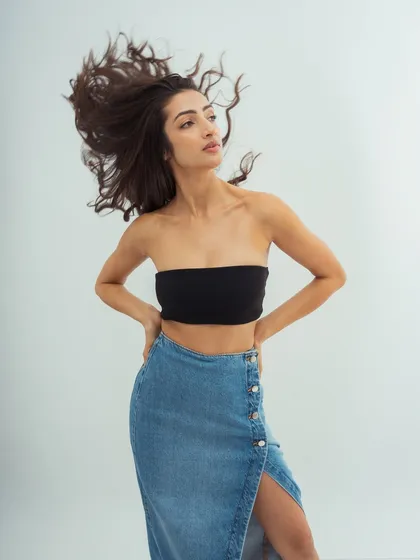 A powerful pose with a focus on the hair's volume and movement. The makeup is kept minimal to balance the drama of the shot.