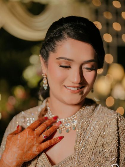 I love this close-up. It highlights the flawless base, the soft shimmer on the eyes, and the perfectly defined brows of her sangeet night makeup.