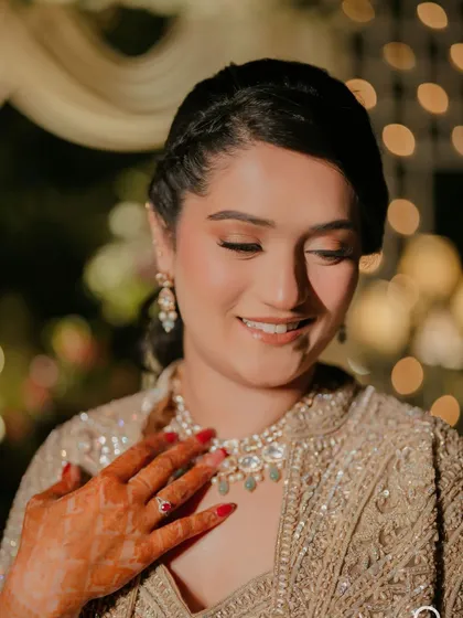 A candid smile from my bride Khushleen at her sangeet. The makeup is soft and glowing, with a focus on skin that looks radiant even in ambient evening light.