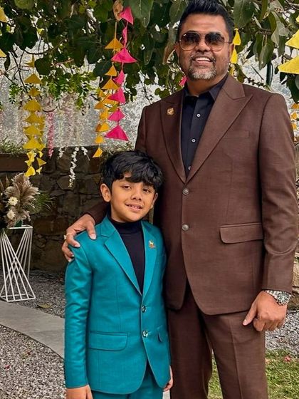 Another shot of Mr. Ritzbora and his son. We love creating coordinated looks for families, ensuring everyone is impeccably dressed for special occasions.