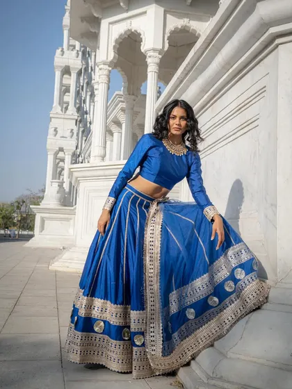 For a look that’s both royal and modern, this royal blue silk lehenga with intricate gota patti work is a showstopper. The rich colour and beautiful flare make it a fantastic choice for a wedding guest who wants to look incredible.