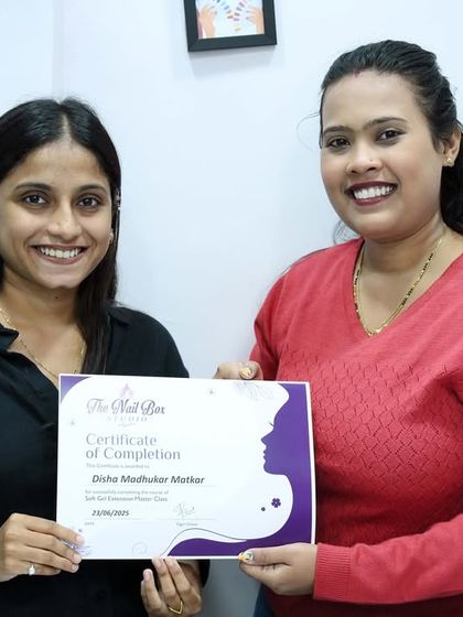 Presenting the certificate of completion to a dedicated student. Her hard work in the class has paid off, and she is now fully equipped with professional skills.