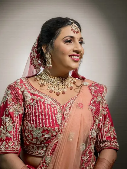 A candid moment of the bride's joyful smile. The soft glam makeup enhances her natural beauty, making her look effortlessly radiant.