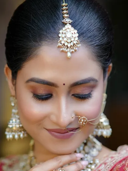 A close-up of a stunning bridal look created for a photoshoot. The focus is on the flawless skin and the beautiful eye makeup.