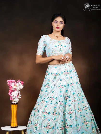 A fresh and modern party look in a light blue lehenga. The makeup is kept bright with a pop of pink on the lips.