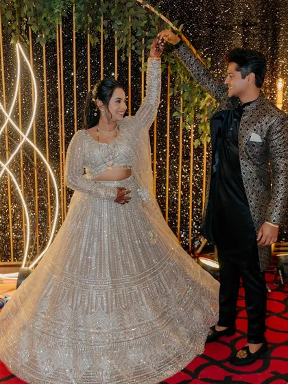 The couple sharing a dance, the bride's lehenga twirling beautifully.