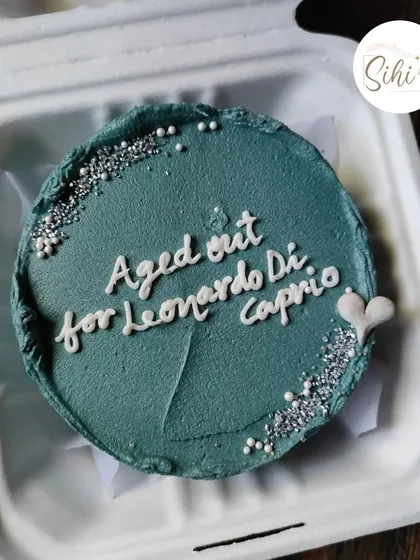 A birthday cake with a topical joke for a fan. This design, which reads "Aged out for Leonardo DiCaprio," is a great example of how we can incorporate pop culture humor into your cake.