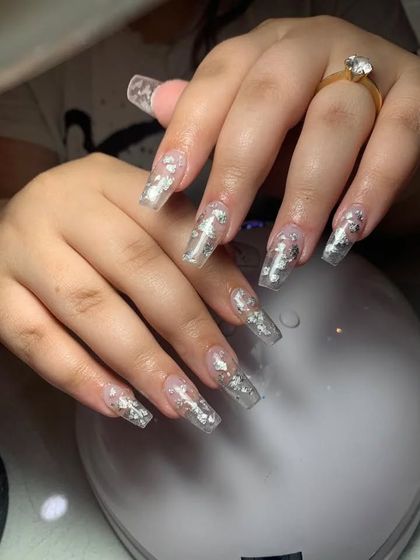 Long, clear coffin nails with embedded silver foil flakes.