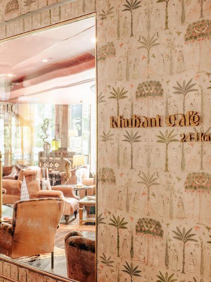 A glimpse into our cafe space. The hand-painted wallpaper and plush velvet seating create an atmosphere that is both elegant and inviting, perfect for a luncheon or sundowner.