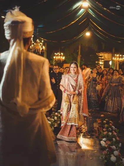 The bride's walk down the aisle is one of the most emotional moments. This over-the-shoulder shot from the groom's perspective captures his first look at his bride, with all the anticipation and love in her eyes.