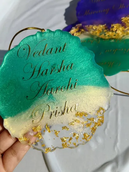 A custom resin car hanging with a family's names. This one is made with a beautiful teal and white resin, with gold flakes for a touch of sparkle.