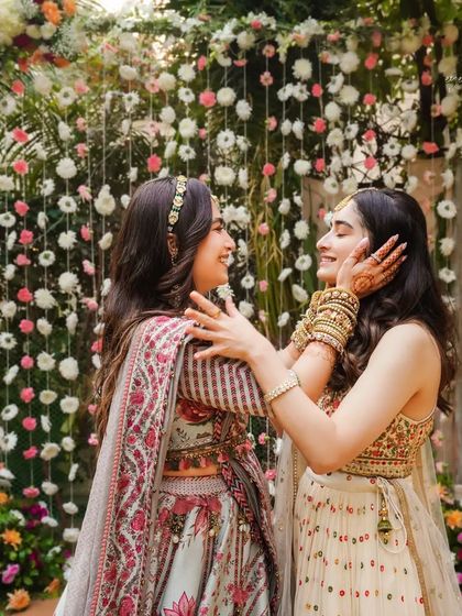 A beautiful, candid moment of affection between the bride and her sister. The genuine smiles and loving gestures are what make these photos so precious.