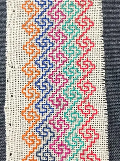 This phone insert features a colorful, multi-row pattern. I love creating these small, functional pieces of art.
