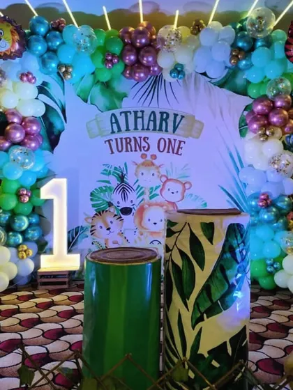 This is one of our most requested themes, a full Jungle Safari setup for a first birthday. I used a custom backdrop with the birthday boy's name, a large light-up number '1', and themed pedestals to create a complete photo-ready zone.