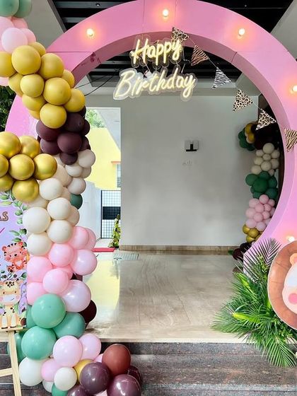 Advitha's 'Wild Four' birthday entrance was a cheerful welcome for all her guests. We used a circular light-up arch, a colorful balloon garland, and a cute lion prop to set a fun, animal-theme party mood.