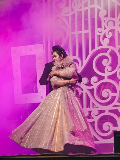 A romantic moment captured amidst the stage smoke. We use special effects to create an intimate and dreamy atmosphere for couple performances.