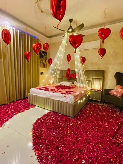 A duplicate of image 33, capturing the beautiful ambiance created by the combination of lights, petals, and balloons.