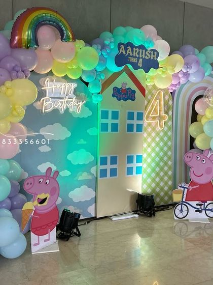 Another perspective of the Peppa Pig party, highlighting the rainbow and cloud details.