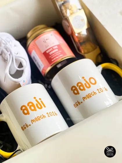 Another angle of the custom 'Aaji' and 'Aajo' mugs, showing the established date. These details make the gift a timeless memento of when they became grandparents.